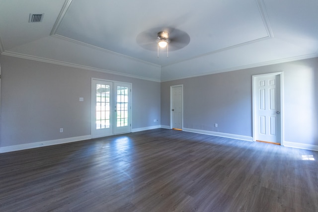 empty room with crown molding, a tray ceiling, dark hardwood / wood-style floors, and french doors