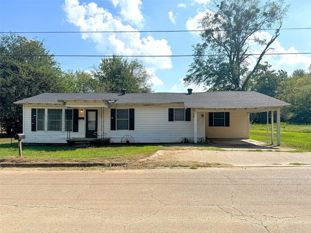 single story home featuring a front yard and a carport