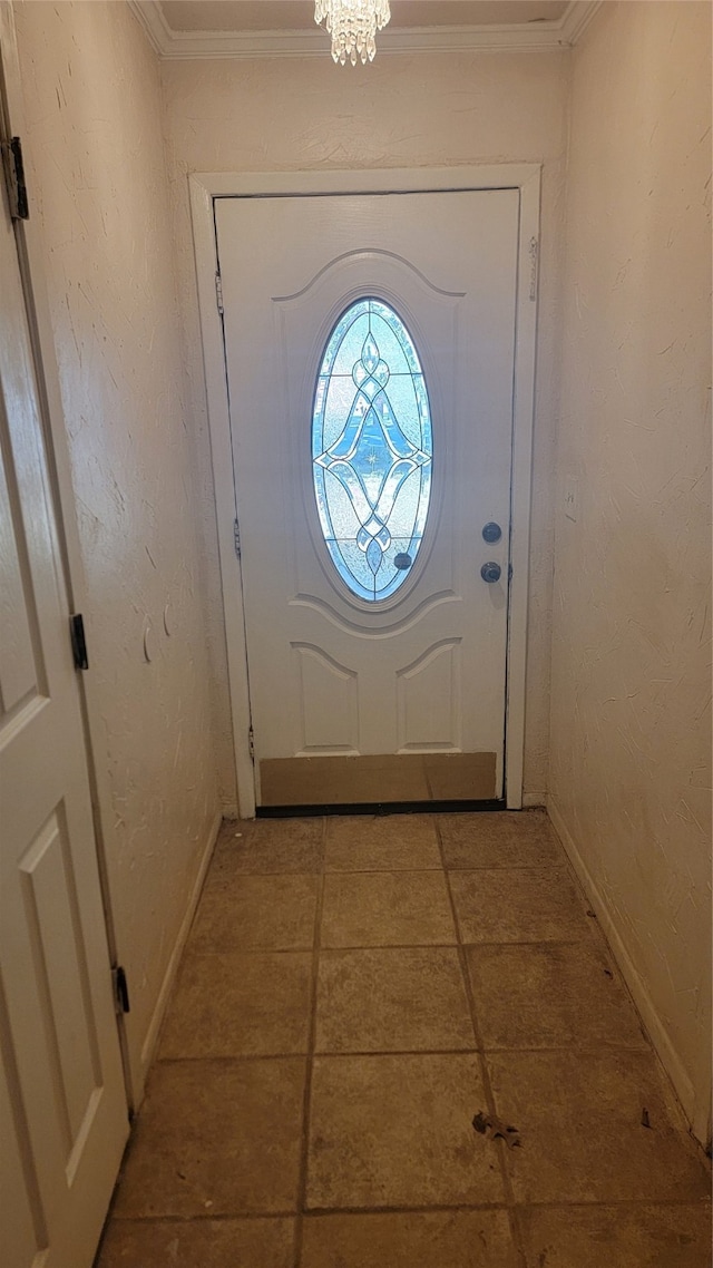 doorway to outside featuring light tile patterned flooring, ornamental molding, and an inviting chandelier