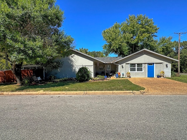 ranch-style home featuring a front yard