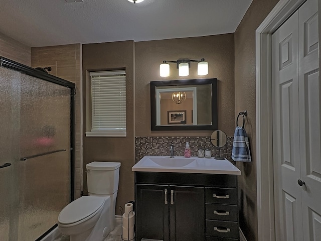 bathroom featuring decorative backsplash, a shower with shower door, vanity, a textured ceiling, and toilet