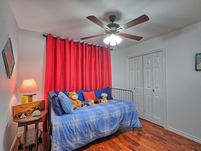 bedroom featuring ceiling fan, a closet, and hardwood / wood-style floors