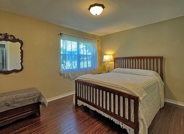 bedroom with dark wood-type flooring