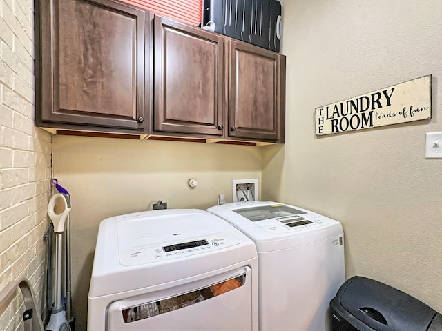 laundry area featuring separate washer and dryer and cabinets