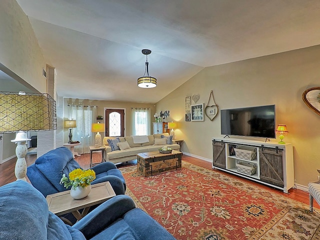 living room with vaulted ceiling and hardwood / wood-style flooring