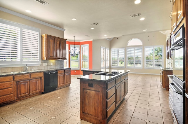 kitchen with tasteful backsplash, a kitchen island, dishwasher, pendant lighting, and sink