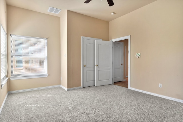 unfurnished bedroom featuring ceiling fan and light colored carpet