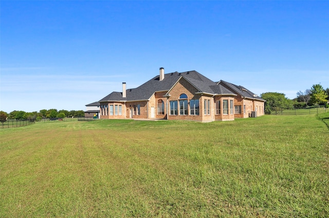 rear view of house with a yard