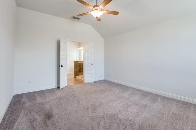 unfurnished bedroom with ceiling fan, light carpet, and vaulted ceiling