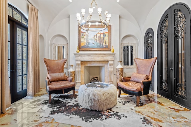 living area with french doors, a chandelier, and lofted ceiling