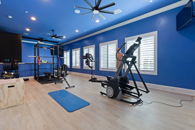 exercise room with ornamental molding, ceiling fan, and light hardwood / wood-style floors