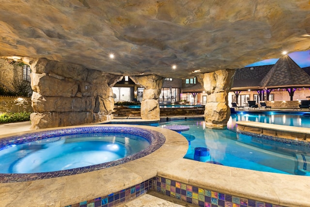 view of pool featuring an indoor in ground hot tub and a gazebo