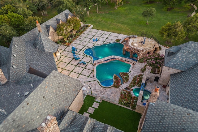 view of swimming pool featuring a lawn, an in ground hot tub, and a patio area