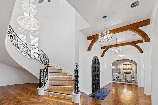 foyer featuring a chandelier and parquet floors