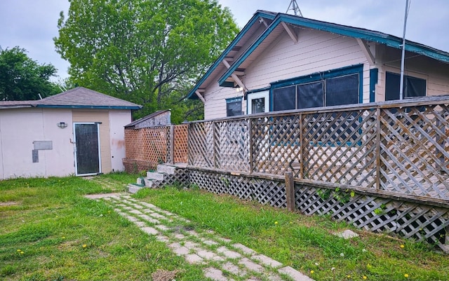 back of house featuring a deck and a yard