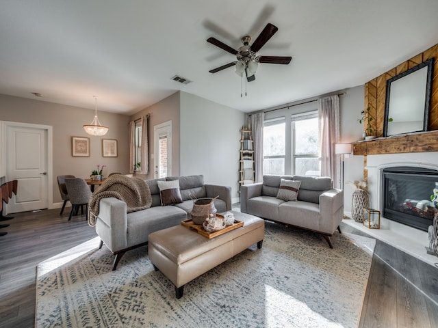 living room featuring ceiling fan and dark hardwood / wood-style flooring