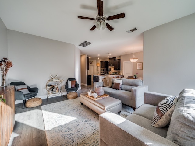 living room with light hardwood / wood-style floors and ceiling fan