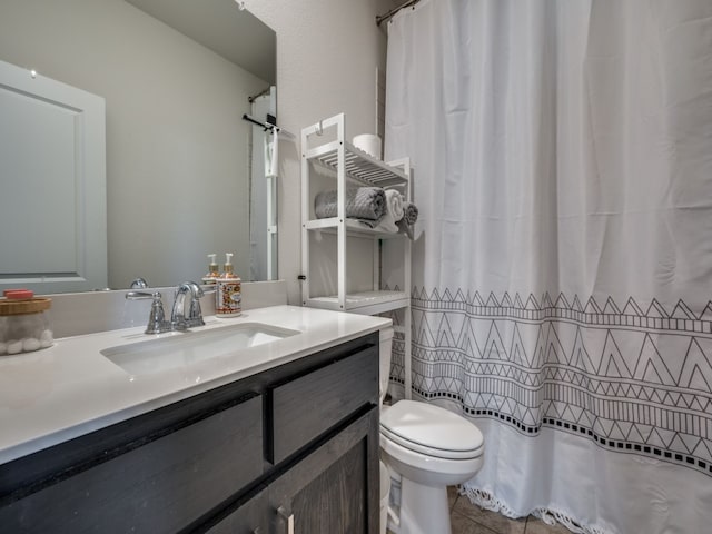 bathroom with a shower with curtain, vanity, tile patterned flooring, and toilet