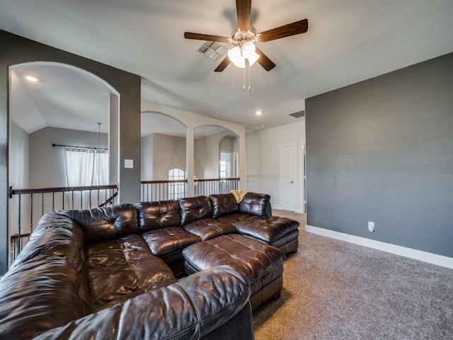 living room with lofted ceiling, ceiling fan, and carpet floors