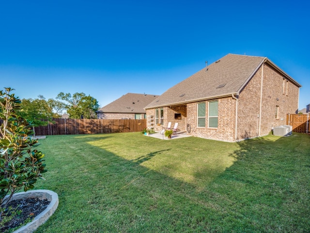 back of property featuring a yard, central AC unit, and a patio area