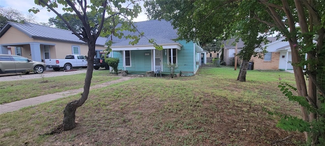 bungalow-style house with a front yard