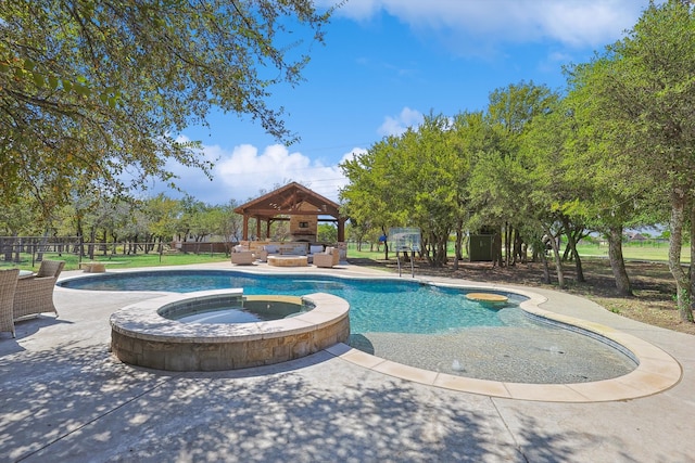 view of pool with an in ground hot tub, a gazebo, and a patio area