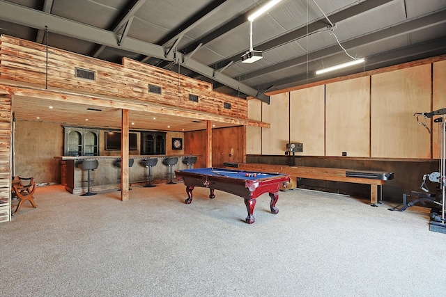 recreation room with pool table, wooden walls, and light carpet