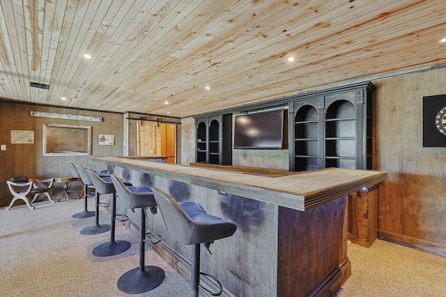 bar with wood ceiling, a barn door, and light colored carpet