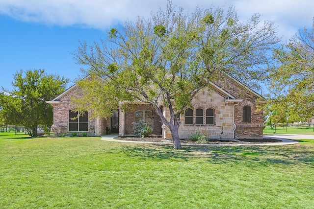 obstructed view of property with a front lawn