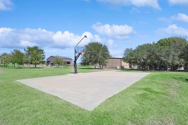 view of sport court featuring a yard