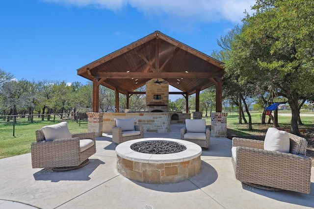 view of patio / terrace with ceiling fan, a gazebo, and a fire pit