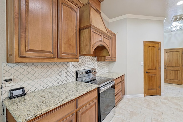 kitchen with tasteful backsplash, light stone countertops, stainless steel range with electric cooktop, and ornamental molding