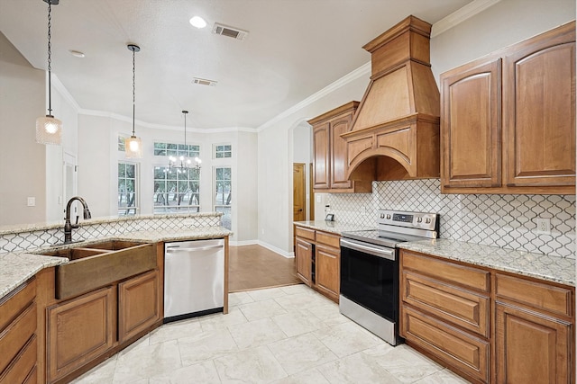 kitchen featuring pendant lighting, appliances with stainless steel finishes, an inviting chandelier, and ornamental molding