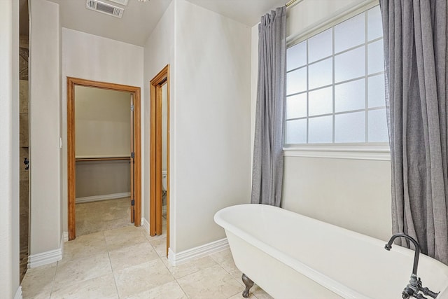 bathroom featuring a tub to relax in and tile patterned floors