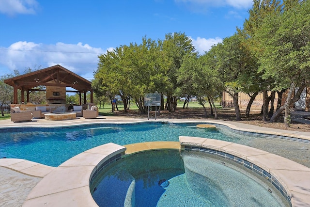 view of swimming pool with an in ground hot tub and a gazebo