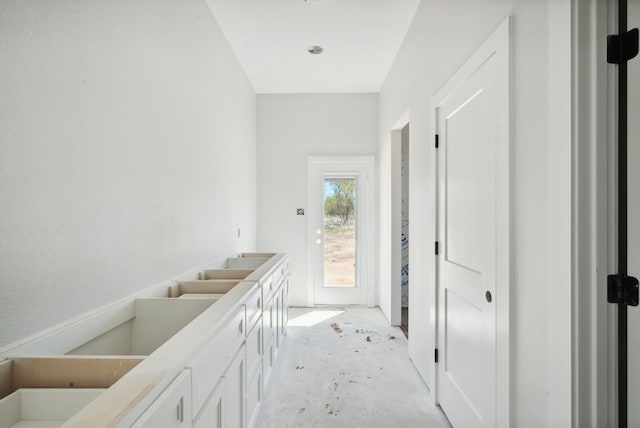 interior space featuring double sink and concrete flooring