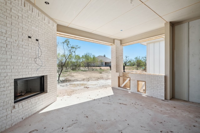 view of patio featuring an outdoor brick fireplace