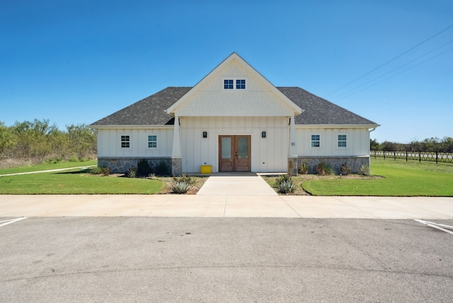 modern inspired farmhouse featuring french doors and a front yard