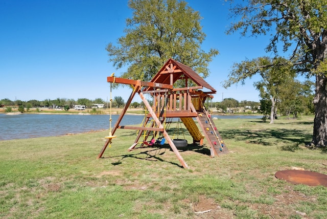 view of play area with a yard and a water view