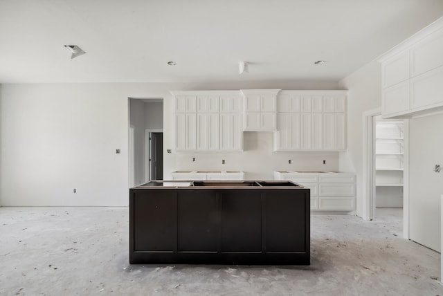 kitchen featuring white cabinets and a center island