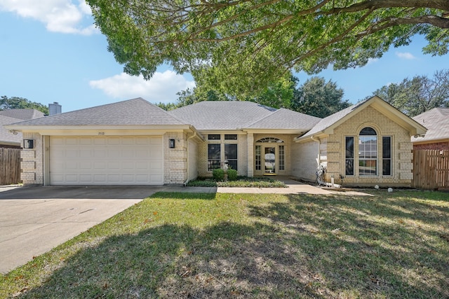 ranch-style home with a garage and a front lawn