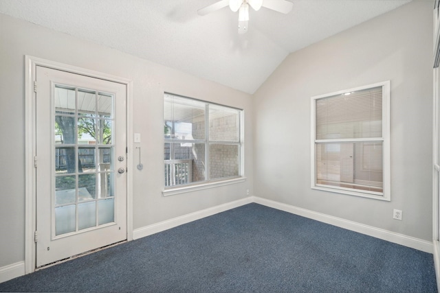 carpeted empty room with vaulted ceiling and ceiling fan