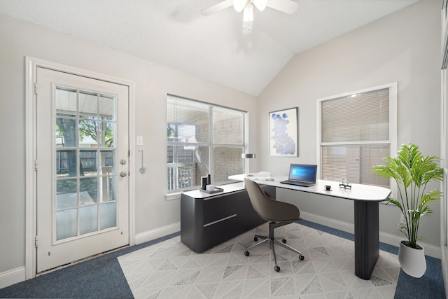 carpeted office space with ceiling fan and vaulted ceiling