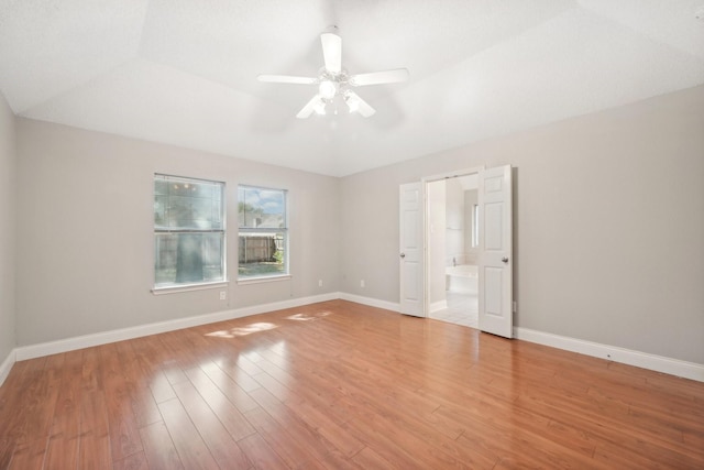 unfurnished room with ceiling fan, lofted ceiling, and light hardwood / wood-style flooring