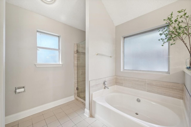 bathroom featuring separate shower and tub, tile patterned flooring, vaulted ceiling, and a textured ceiling