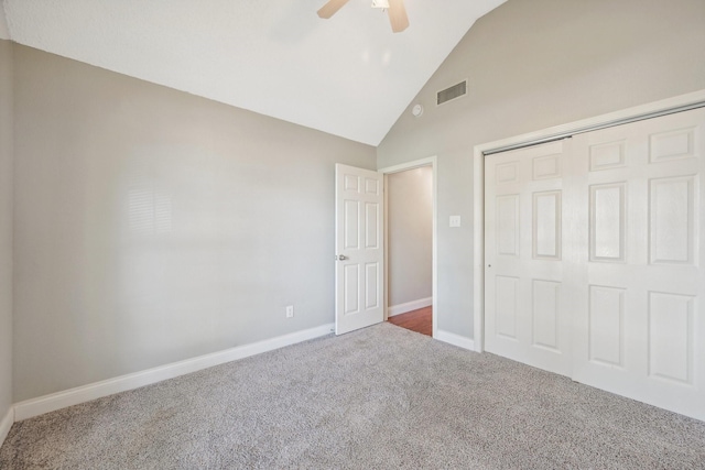 unfurnished bedroom with carpet flooring, ceiling fan, vaulted ceiling, and a closet