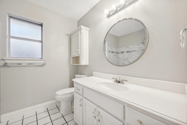 bathroom featuring tile patterned flooring, vanity, toilet, and a textured ceiling