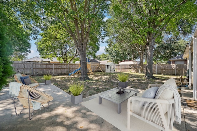 view of patio featuring an outdoor hangout area, a playground, and a storage unit