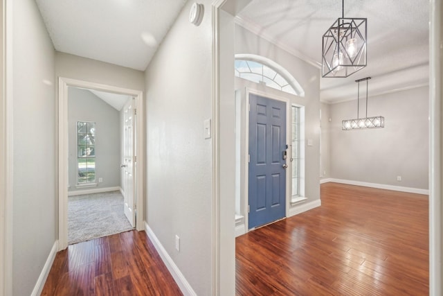 entrance foyer with plenty of natural light, wood-type flooring, and an inviting chandelier