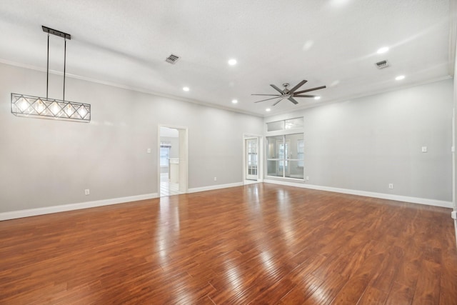 unfurnished room with a textured ceiling, ceiling fan, dark hardwood / wood-style floors, and ornamental molding